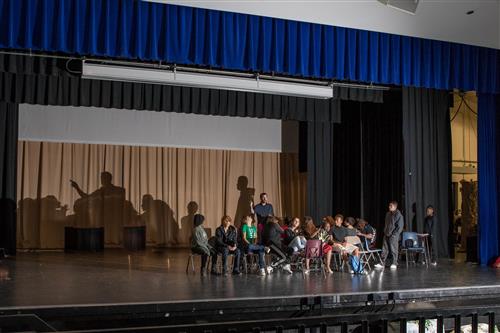 Students in drama class on stage 